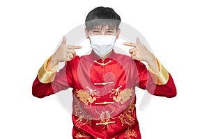 Asian man in red mandarin collar dress wearing Anti virus mask isolated on white background with clipping path. Chinese new year