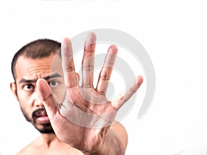 Asian man showing stop hand sign on white background