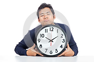 Asian man is sleepy with a clock