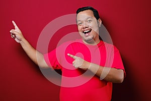 Asian Man Smile to camera while Presenting Something on His Side with Copy Space