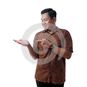 Asian Man Smiling at Camera While Showing Something on His Empty Hand