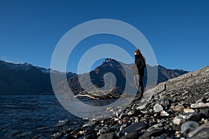 Asian man stand at the front of beautiful view close to the lake with sunrise in New Zealand