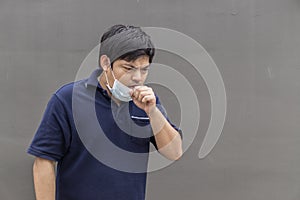 Asian man in the street wearing protective masks., Sick man with flu wearing mask and blowing nose into napkin as epidemic flu con