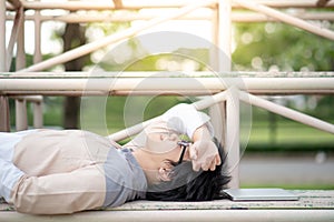 Asian man student lying on cheer stand