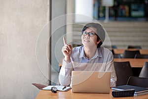 Asian man student pointing finger in college library