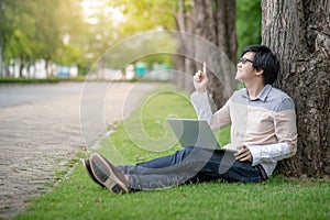 Asian man student pointing finger in college park