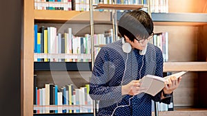 Asian man student reading book in library