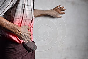 Asian man suffering from abdominal pain. It can be caused by stomach ache, enteritis, colitis, appendicitis, hepatitis, food