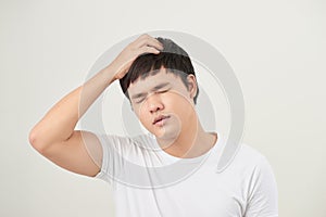 Asian man suffering from headache, vertigo, hangover, migraine,