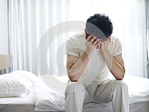 Asian man suffering from insomnia photo