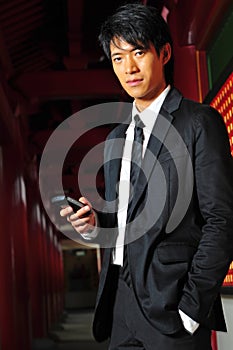 Asian Man In Suit with Phone