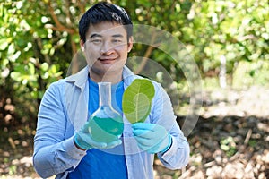 Asian man teacher do science experiment lesson outdoor.