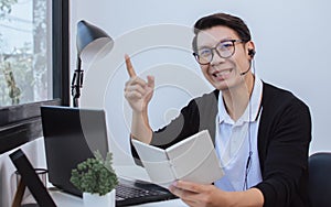 Asian man teaching students online by using laptop