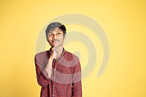 asian man thinking something and looking up