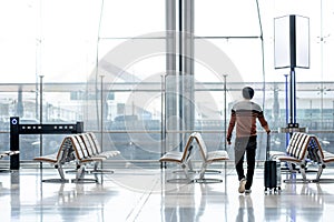 Asian man tourist walking in airport terminal