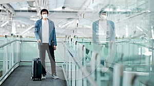 Asian man tourist wearing mask in airport terminal