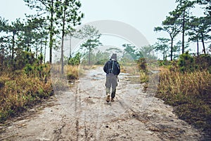 Asian men travel photograph nature. Travel relax. Walk on the path. Nature Study in the Jungle. Thailand