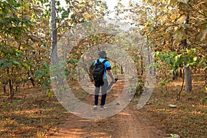 Asian men travel photograph nature. Travel relax. Walk on the path. Nature Study in the Jungle.