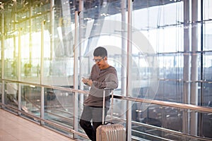 Asian man traveler using mobile phone in airport,Lifestyle using cell phone connection concept