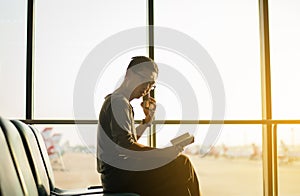 Asian man traveler using mobile phone internet and wifi in airport,Lifestyle using cell phone connection concept