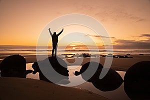 Asian man traveller visit at Moeraki Boulder, New Zealand