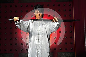 Asian Man Unsheading A Sword