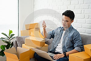 Asian man with unsuccess business online shopping crying and serious face unhappy mood photo