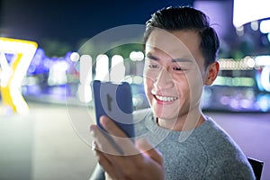 Asian man use phone outdoor