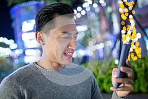 Asian man use phone outdoor