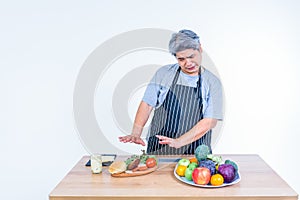 Asian man uses his hand reject hamburger on wooden table