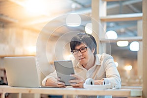 Asian man using app on digital tablet