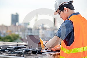 Asian man using drone and laptop for construction site survey