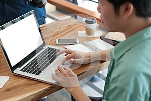 Asian man using laptop in coffee shop