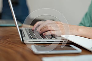 Asian man using laptop computer in cafe,