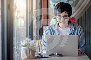 Asian man using laptop computer for remote working