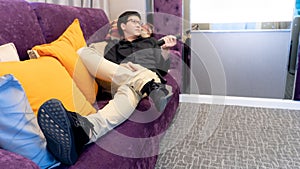 Asian man using remote controller in living room