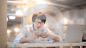 Asian man using smartphone on social media