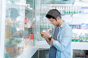 Asian man was happily shopping for medicines in the pharmacy, Medical healthcare concept