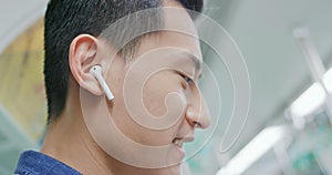 Asian man wear wireless earbuds