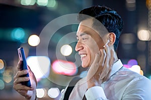 Asian man wear wireless earbuds photo