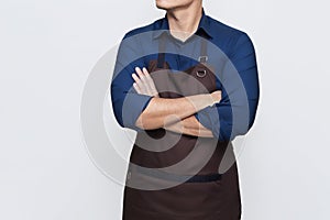 Asian Man wearing apron with folded hands, confident and calm gesture, isolated