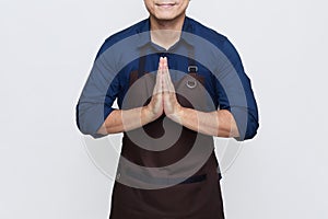 Asian man wearing Apron showing hospitality, isolated