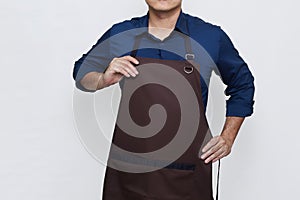 Asian Man wearing Apron wearing and tidying his apron