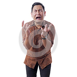 Asian Man Wearing Batik Shirt Crying Hard