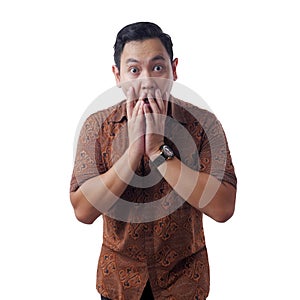 Asian Man Wearing Batik Shirt Shocked and Closing his Mouth