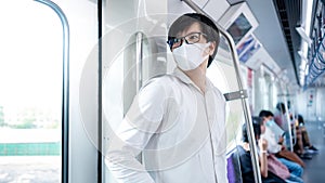 Asian man wearing face mask on skytrain