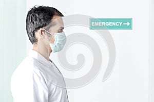 Asian man wearing a flu mask on the emergency room