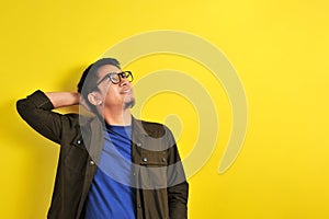 Asian man wearing glasses smiling look at copy
