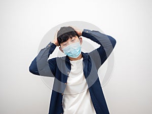 Asian man with mask headach and feel bad touch his head by hand on white isolated background photo