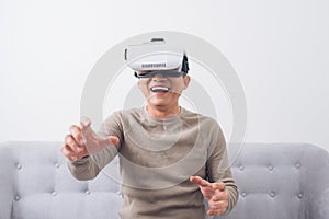 Asian man wearing virtual reality goggles or VR headset